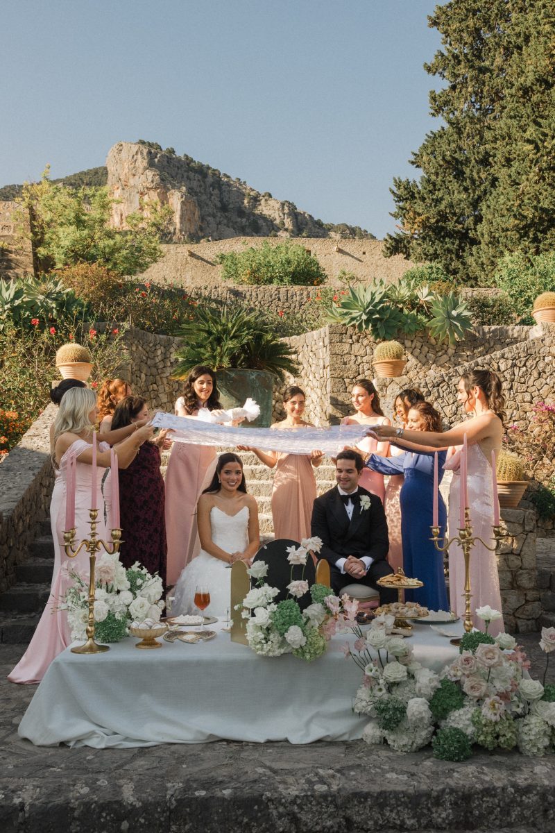 Rosie and Masoud's Persian ceremony: the sofreh aghd and the cloth held above them by their friends, in Mallorca