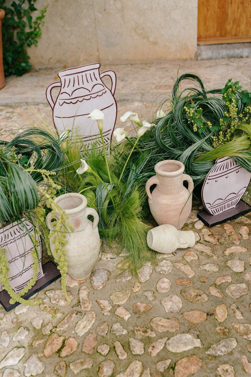 Jarras de cerámica y plantas a lo largo del pasillo de la ceremonia en Son Togores
