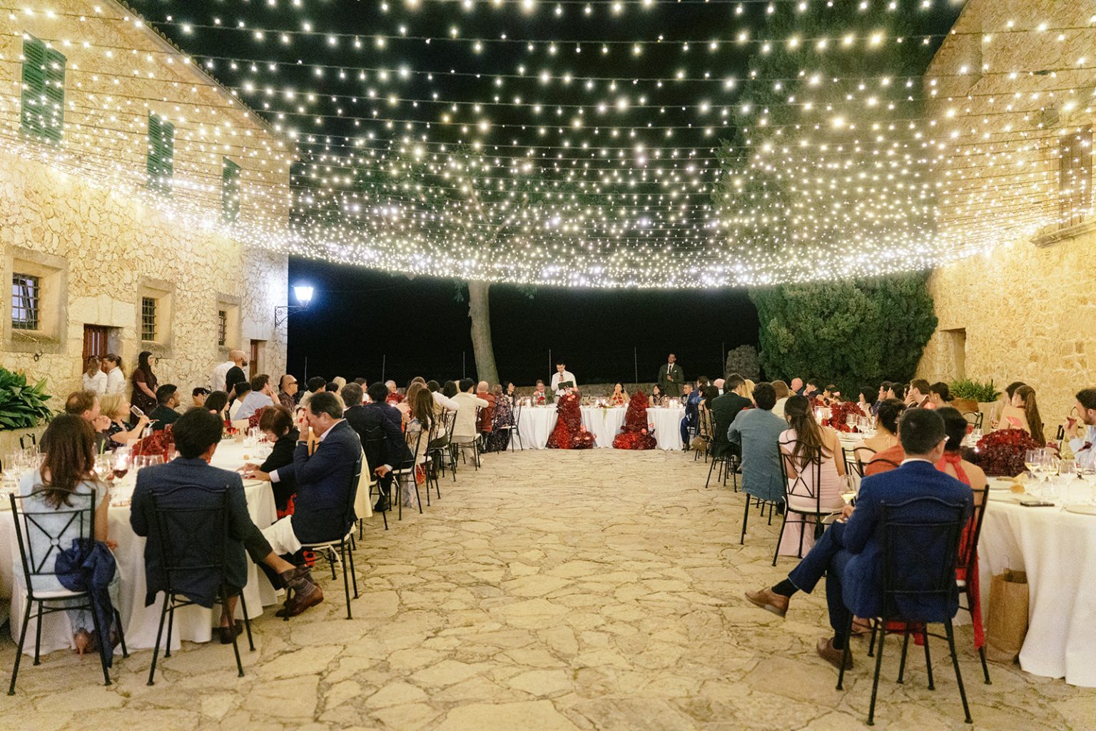 Evening dinner in the courtyard at Son Berga, in Alaró, under string lights